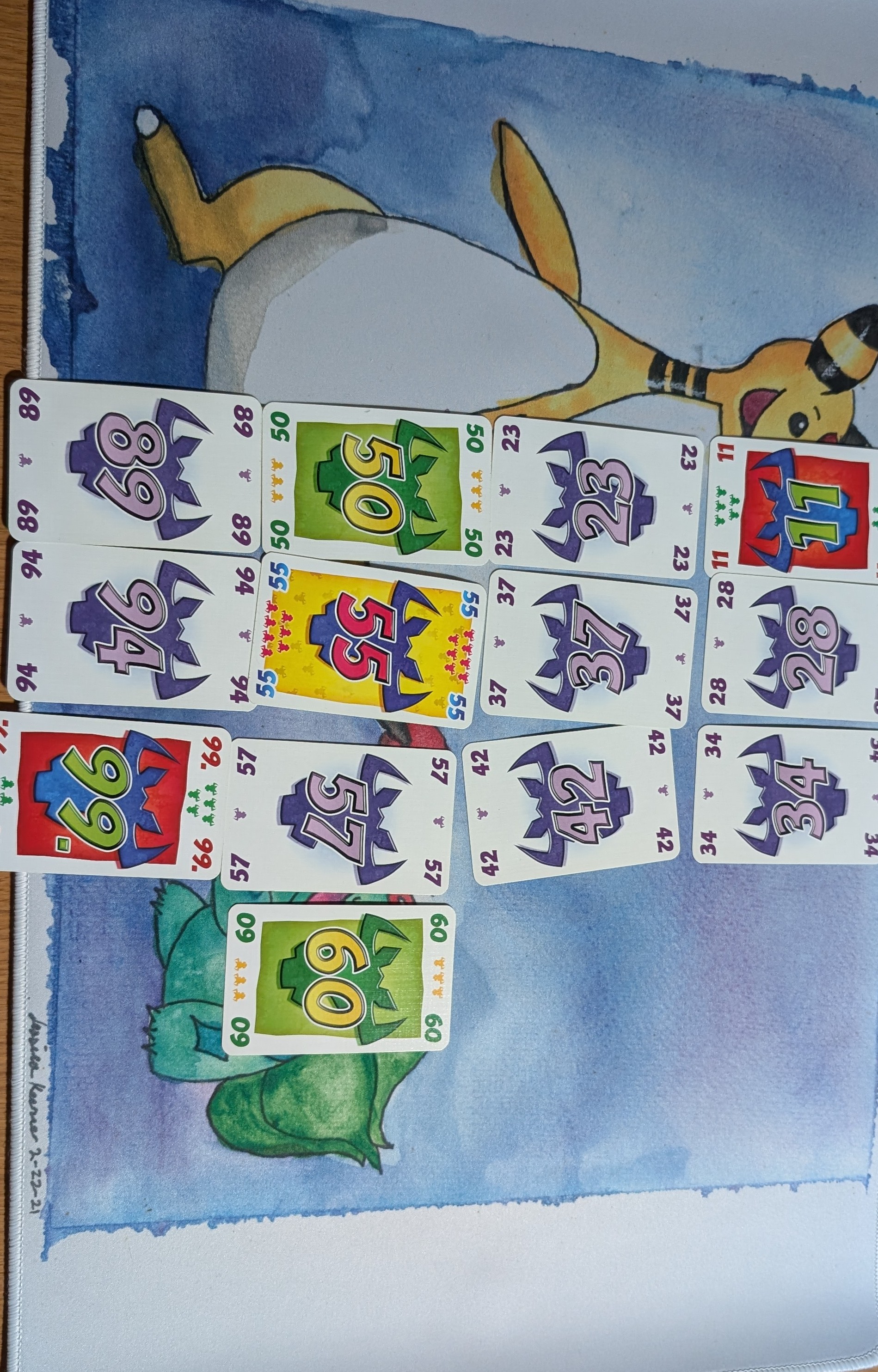 A game of 6 Nimmt on-going with four rows of 3 to 4 cards in each. The cards from previous step have been added to the ends of their corresponding rows.