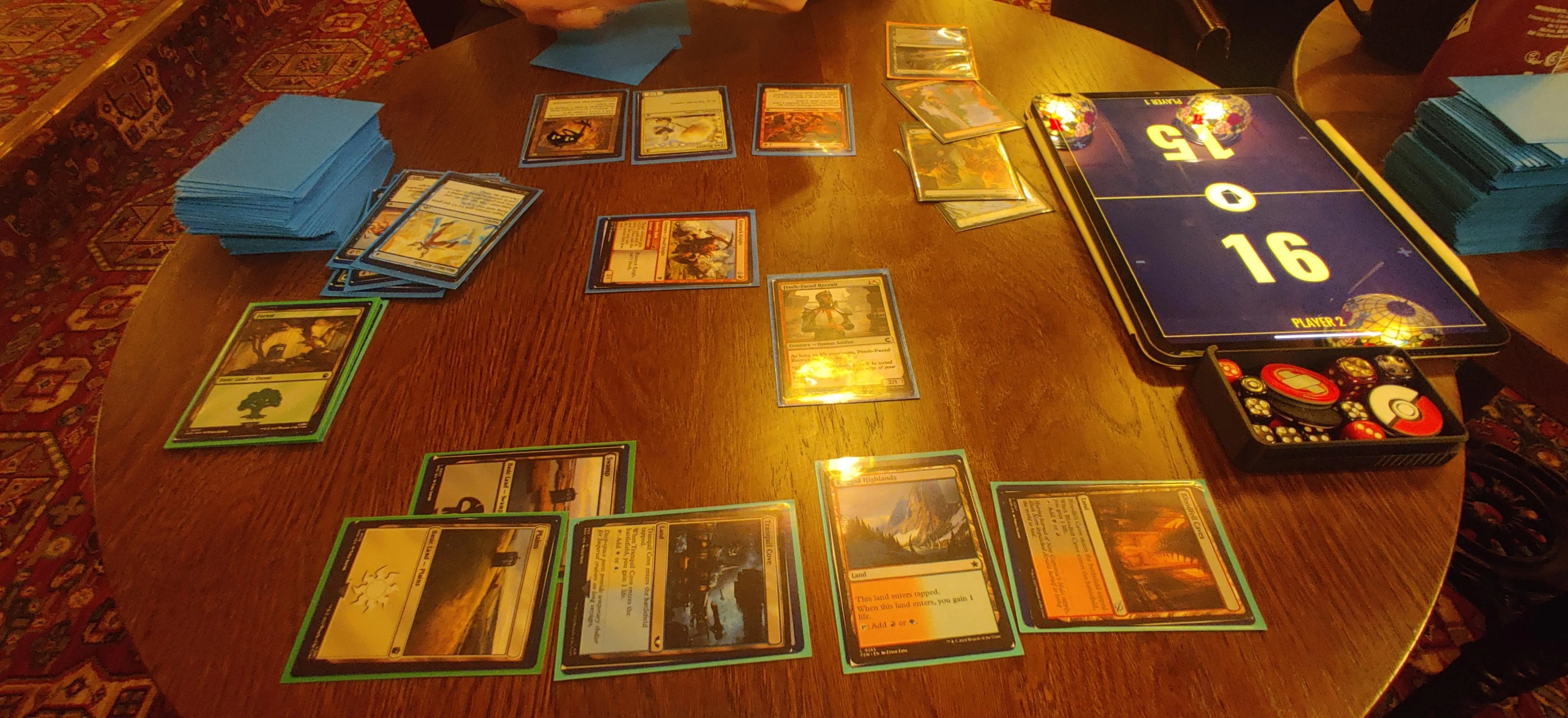 An on-going game of Magic the Gathering played in a pub.