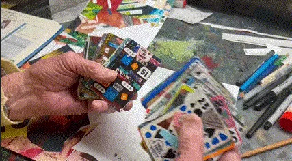 A deck of cards being browsed through. The cards are all pieces of art themselves, all different, all colourful and beautiful.
