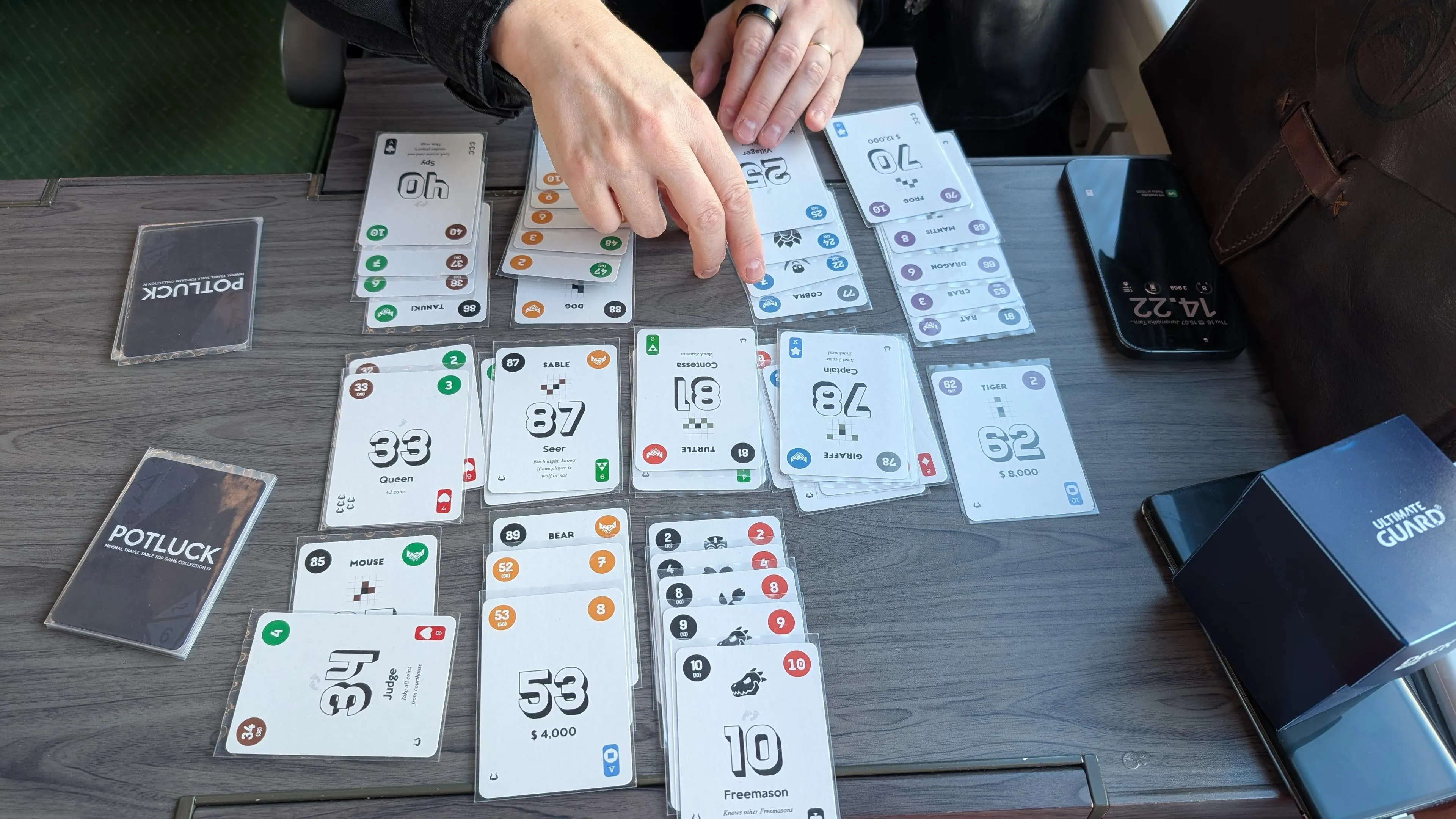 Lost Cities being played in a train with custom cards