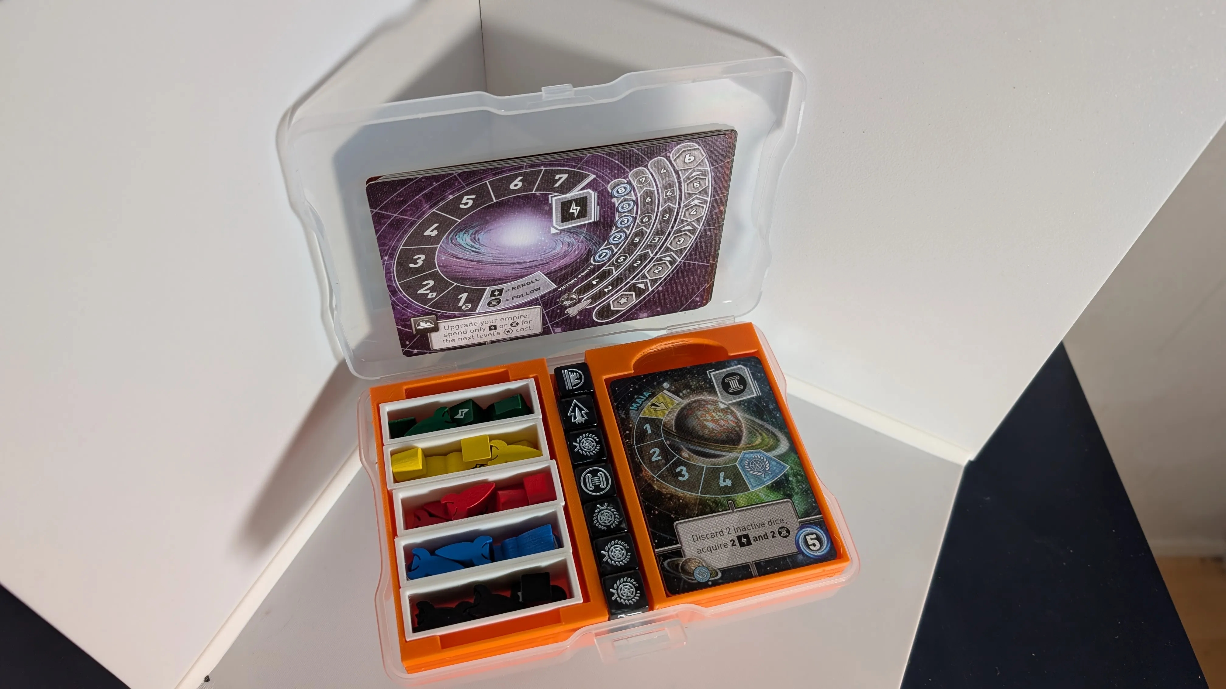 A photo caddy case with a custom 3D printed insert filled with Tiny Epic Galaxies cards, tokens and dice.
